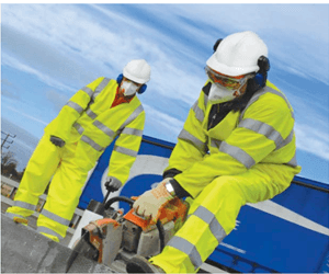 Worker on an exposed roof wearing multiple items of PPE: hi-vis, hard hat, ear defenders and a fall-arrest harness